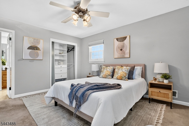 151 East Prospect Street Clark, NJ 07066 - Photo 17 of 31 a bedroom with a bed and a chandelier