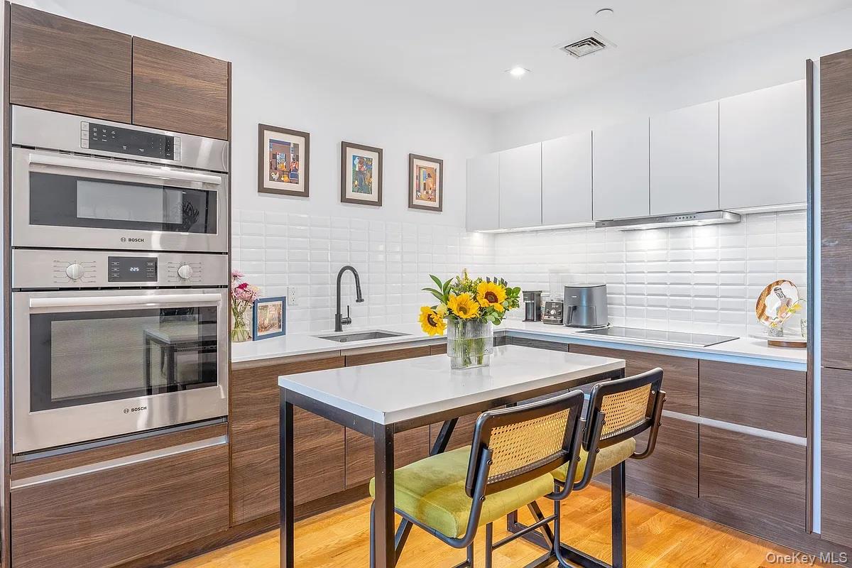 a kitchen with a table chairs and microwave