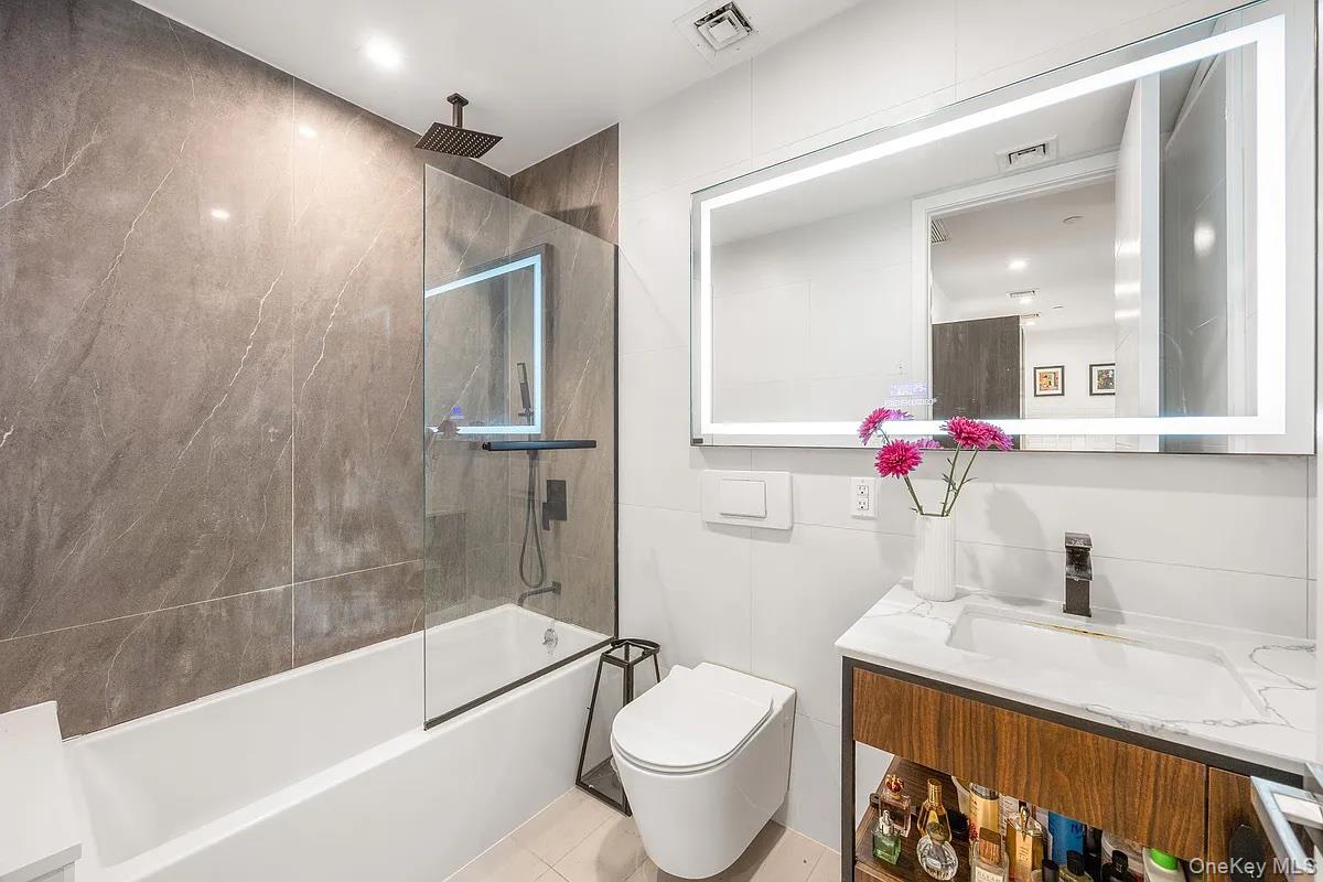 1110 Madison Street, Unit 3B Brooklyn, NY 11221 - Photo 5 of 11 a bathroom with a granite countertop sink a toilet and shower