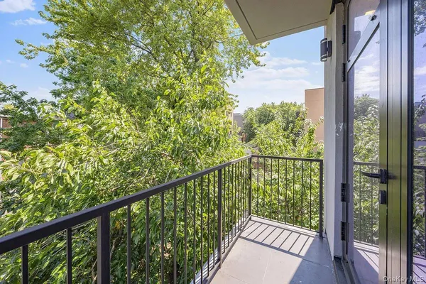 a view of a balcony with wooden floor