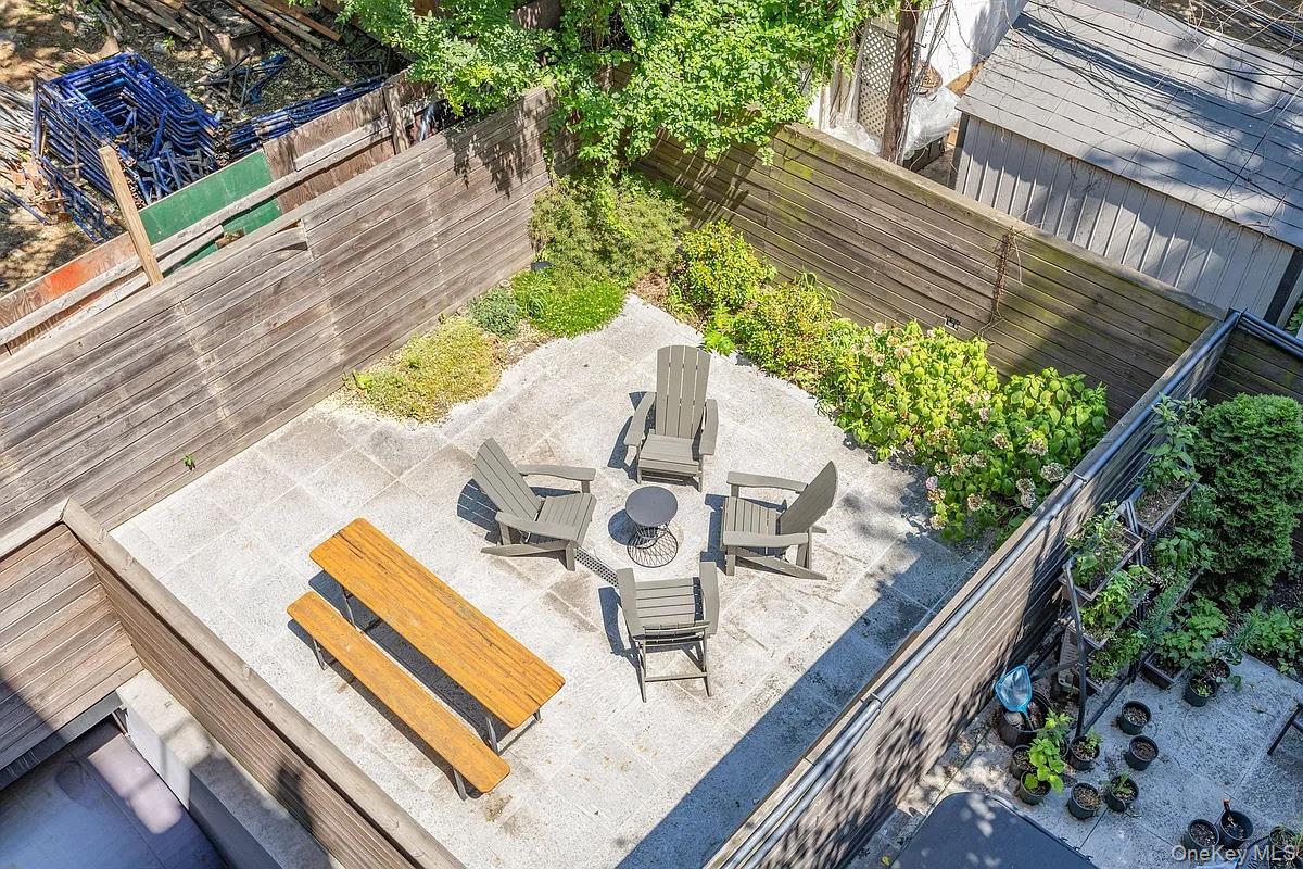 1110 Madison Street, Unit 3B Brooklyn, NY 11221 - Photo 9 of 11 a view of a balcony with chairs and wooden floor