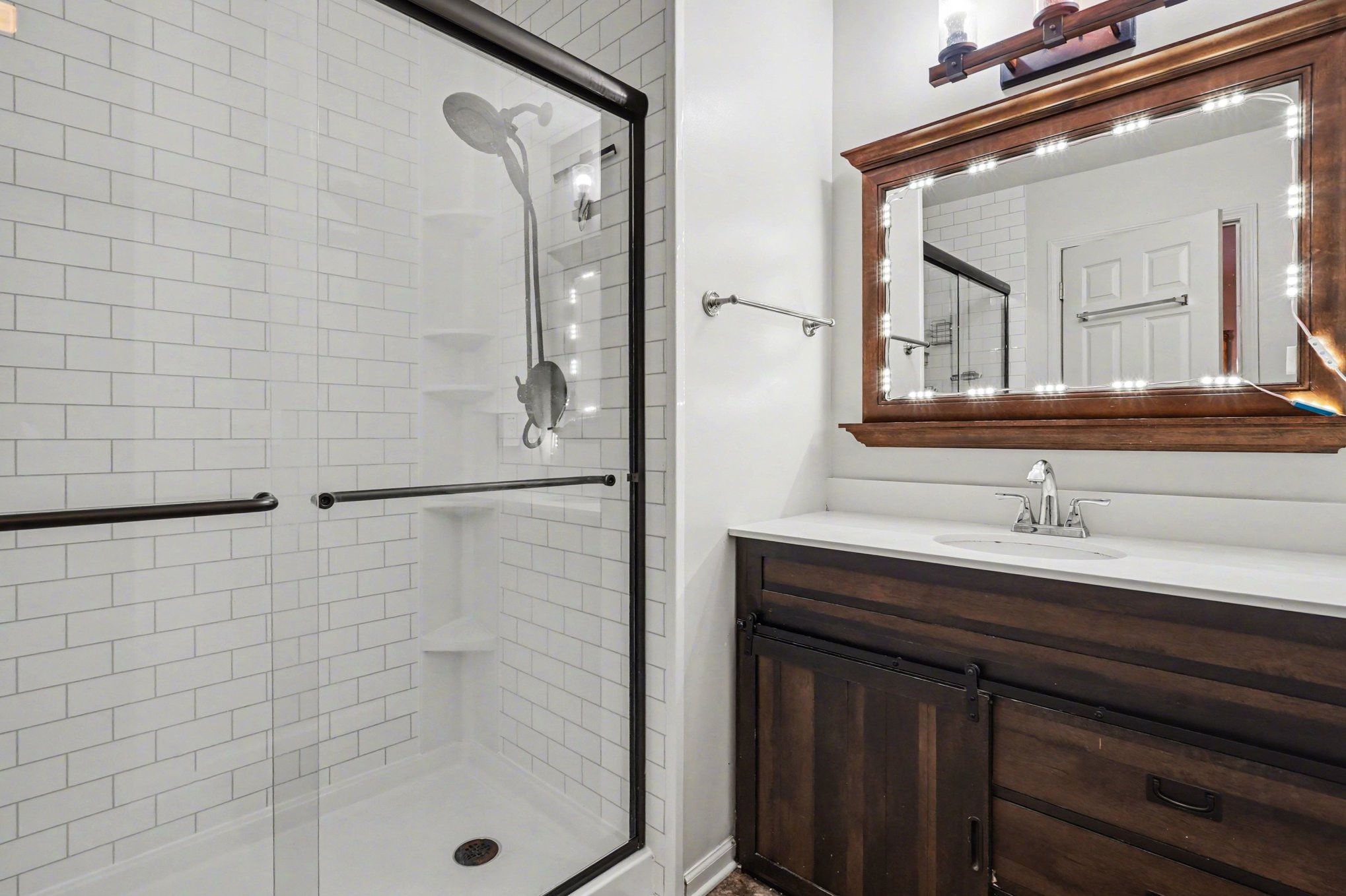 1510 Rapids Road Portland, TN 37148 - Photo 18 of 33 a bathroom with a sink a mirror and shower
