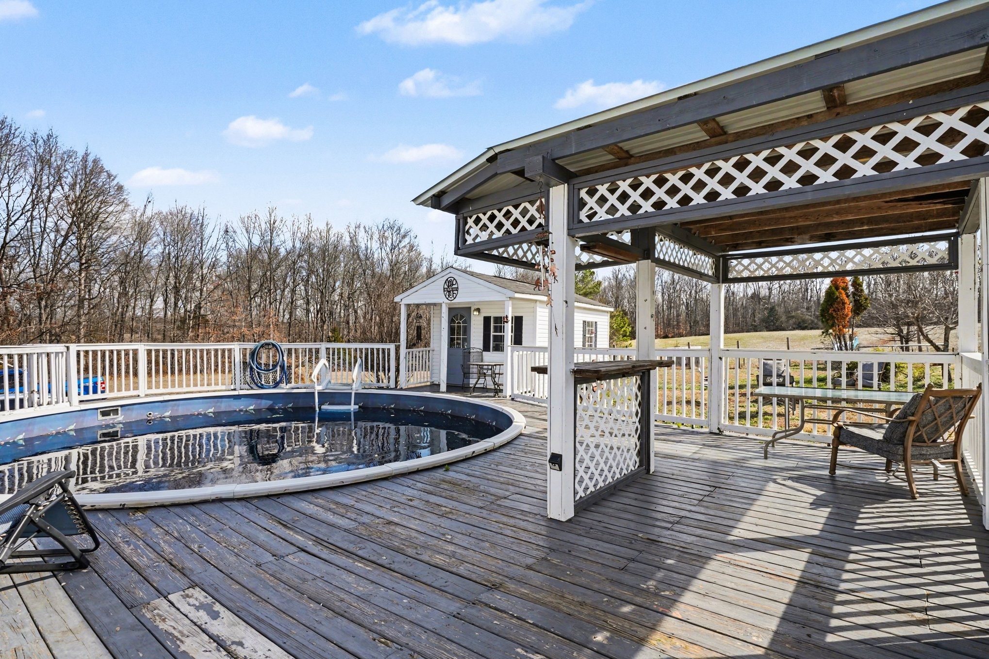 1510 Rapids Road Portland, TN 37148 - Photo 5 of 33 a view of a chairs and table on the wooden deck