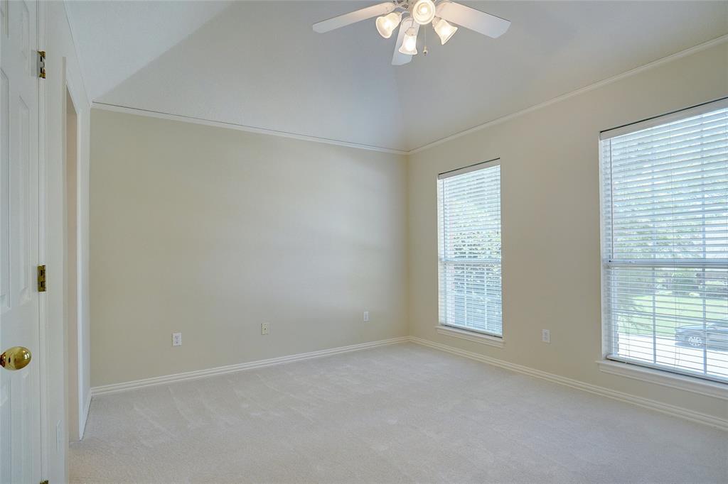 203 Donley Court Southlake, TX 76092 - Photo 16 of 21 an empty room with a chandelier fan and windows