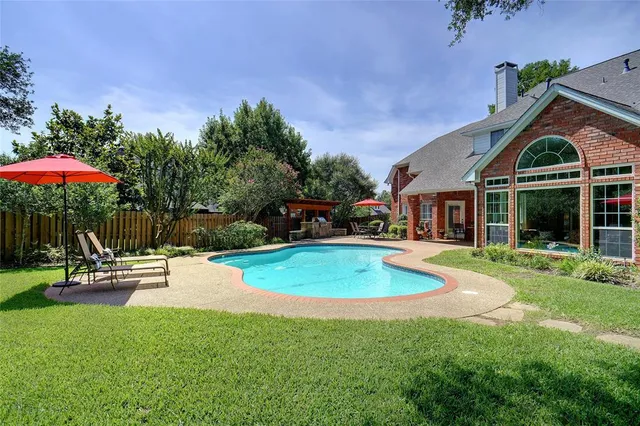 a view of a house with backyard porch and sitting area