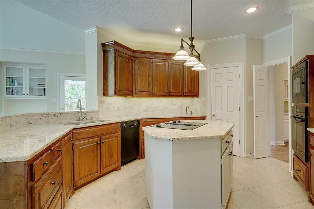 203 Donley Court Southlake, TX 76092 - Photo 9 of 21 a kitchen with a sink stove and refrigerator