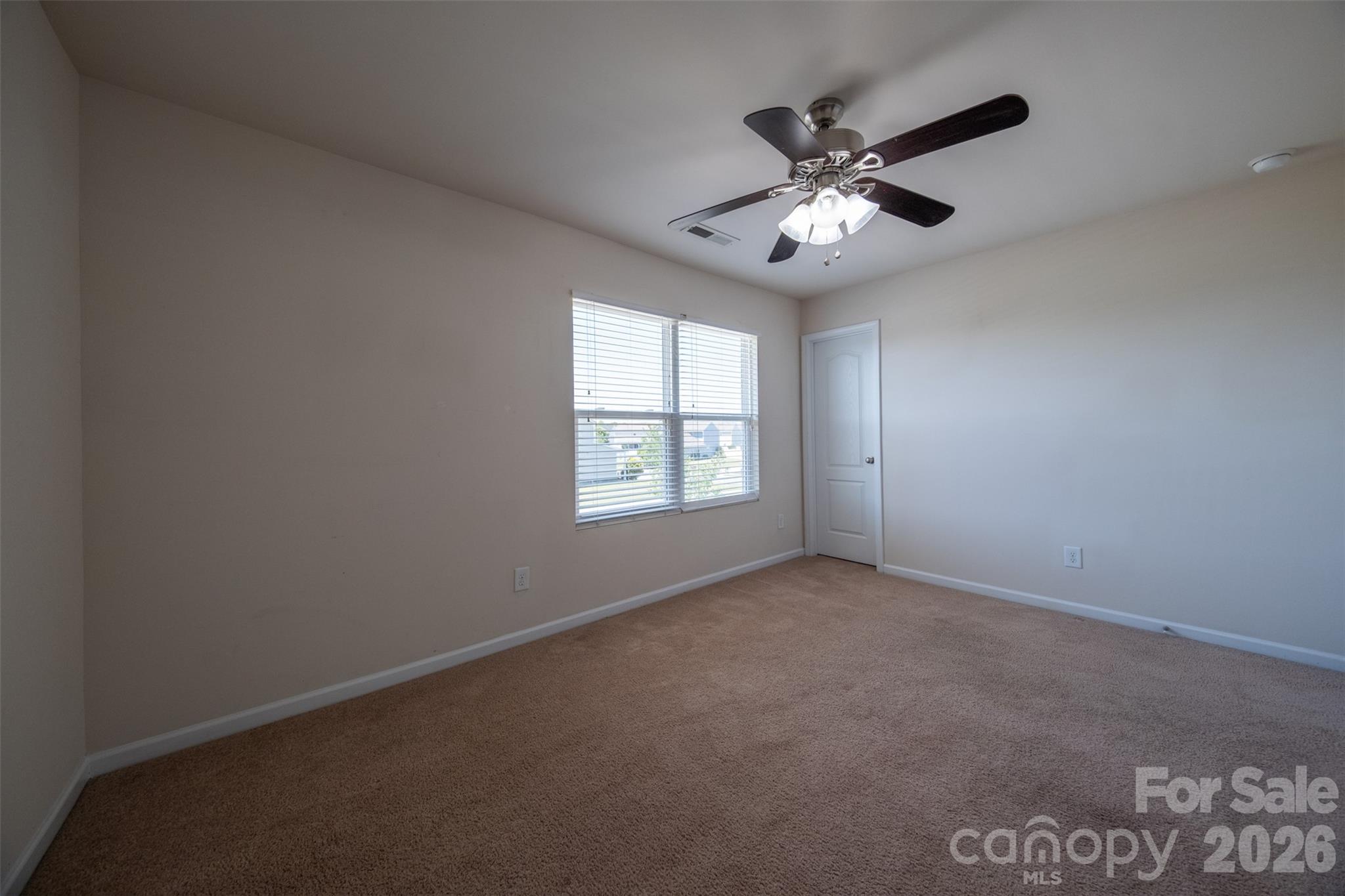 3006 Houndscroft Road Indian Trail, NC 28079 - Photo 27 of 39 an empty room with windows and ceiling fan