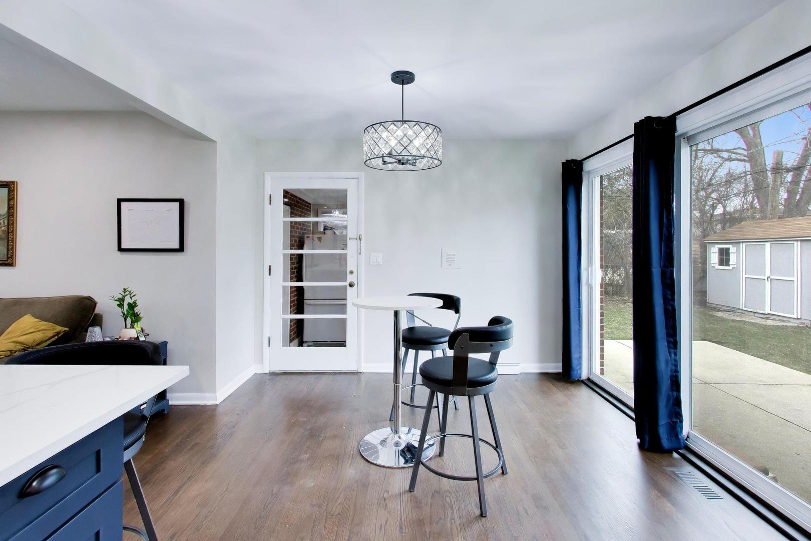108 West Sunset Road Mount Prospect, IL 60056 - Photo 12 of 40 a view of a dining room with furniture window and wooden floor