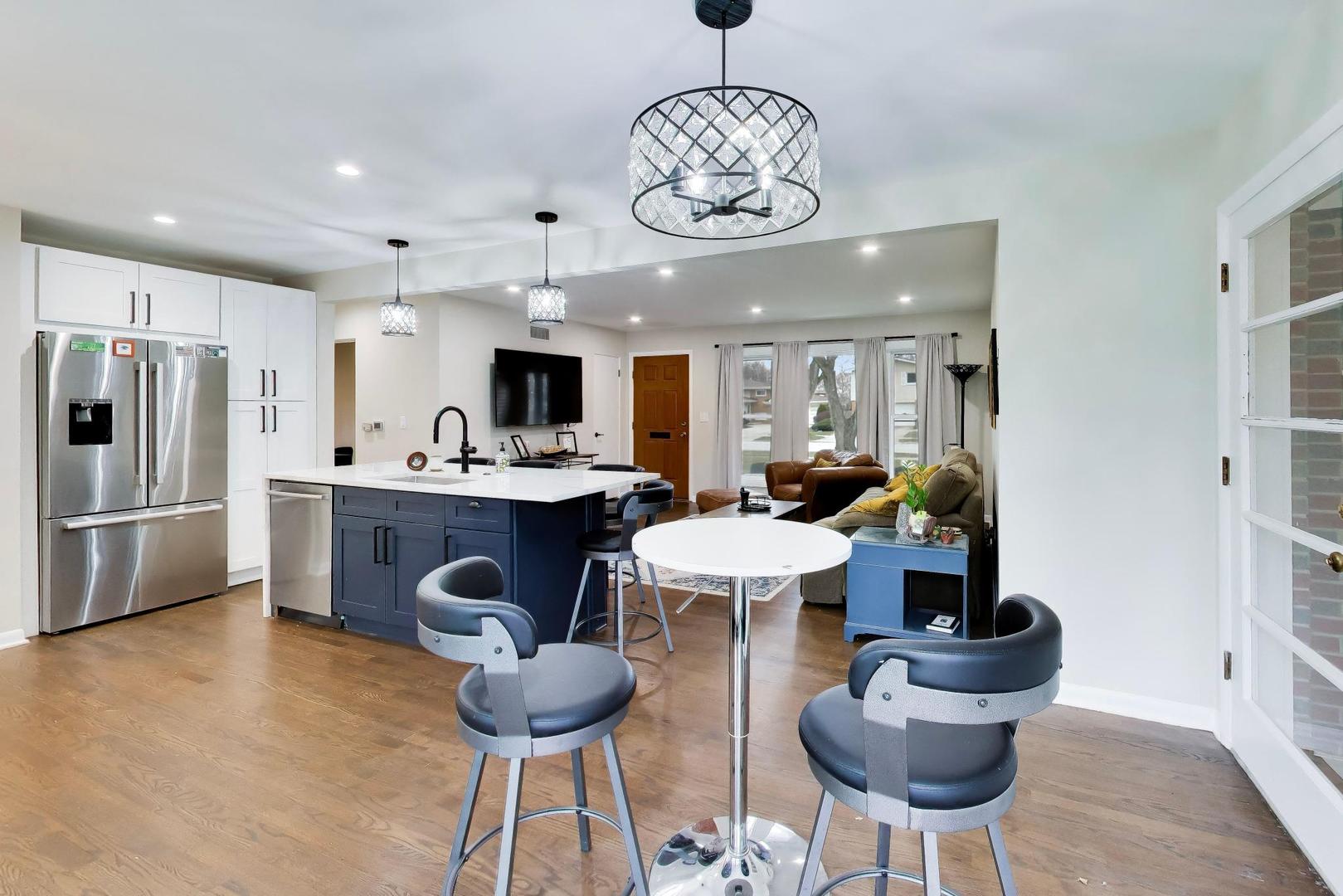 108 West Sunset Road Mount Prospect, IL 60056 - Photo 14 of 40 a kitchen with stainless steel appliances kitchen island granite countertop a dining table and chairs