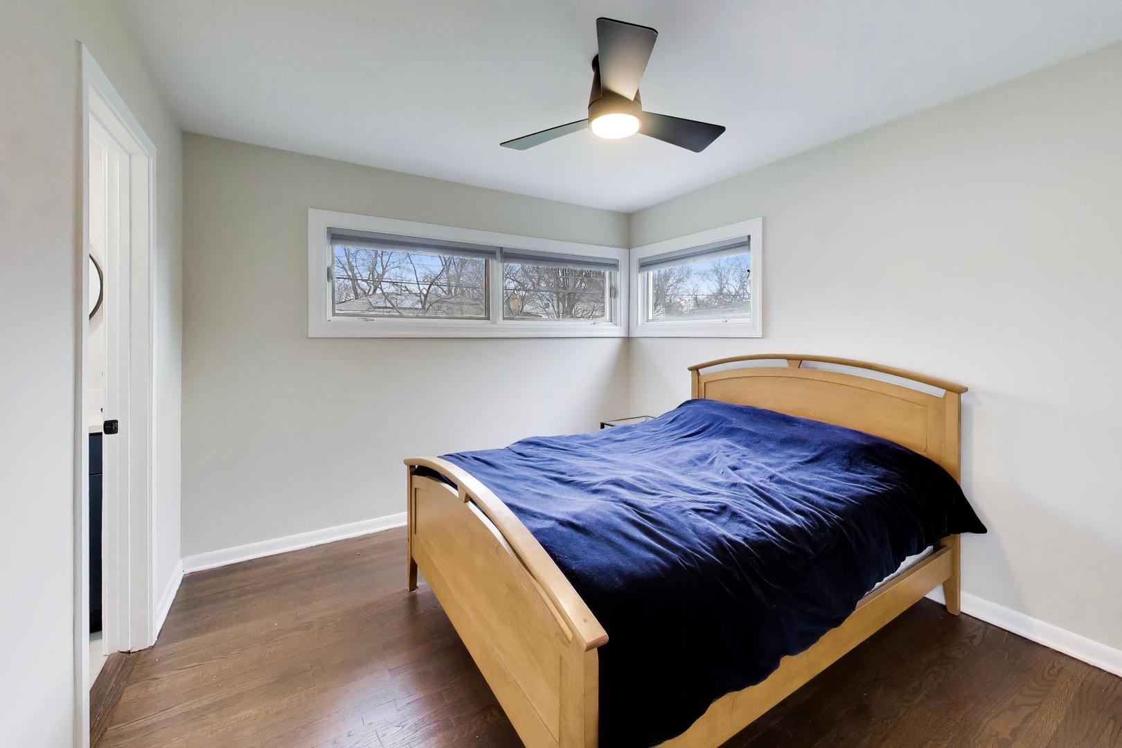 108 West Sunset Road Mount Prospect, IL 60056 - Photo 15 of 40 a bedroom with a bed and a chandelier