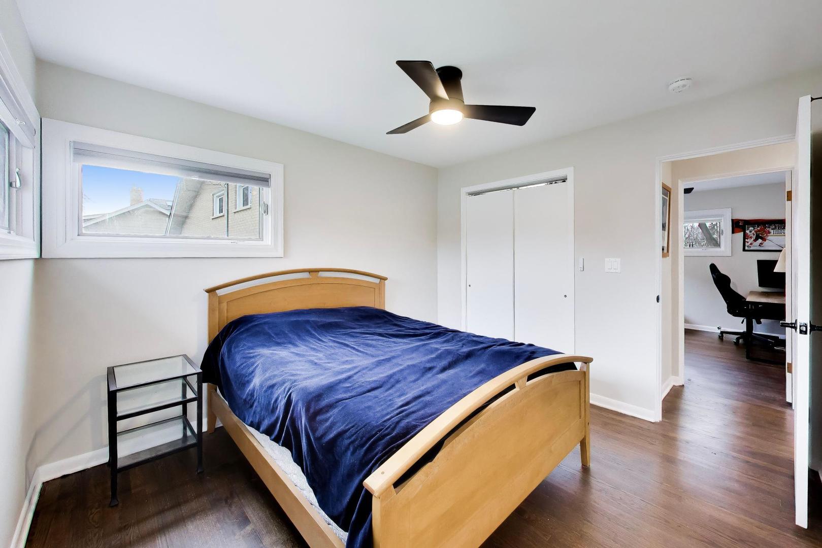 108 West Sunset Road Mount Prospect, IL 60056 - Photo 16 of 40 a bedroom with a bed and a chandelier