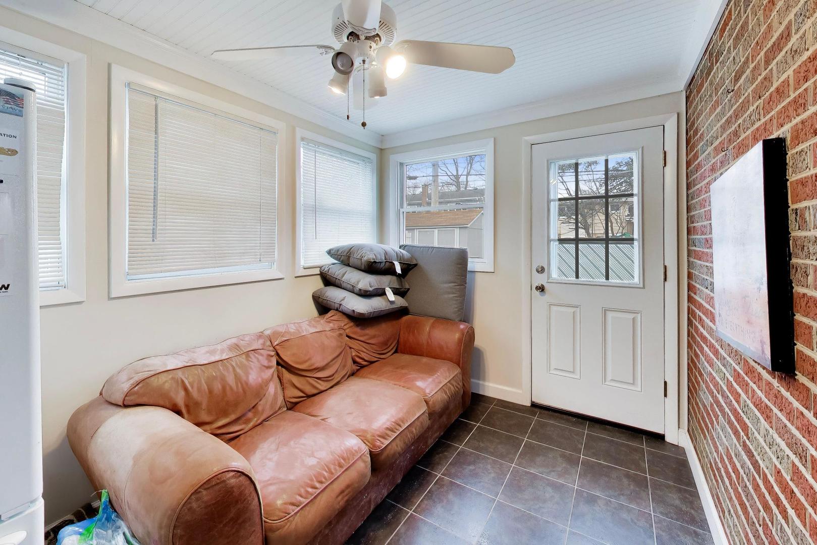 108 West Sunset Road Mount Prospect, IL 60056 - Photo 24 of 40 a living room with furniture and a flat screen tv