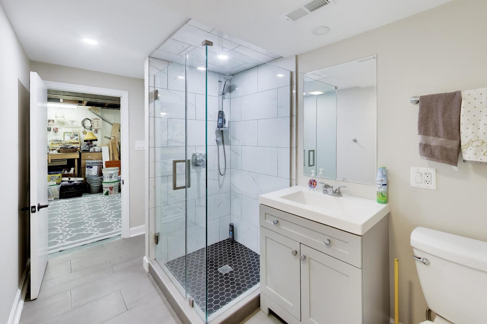 108 West Sunset Road Mount Prospect, IL 60056 - Photo 30 of 40 a bathroom with a sink toilet vanity and shower