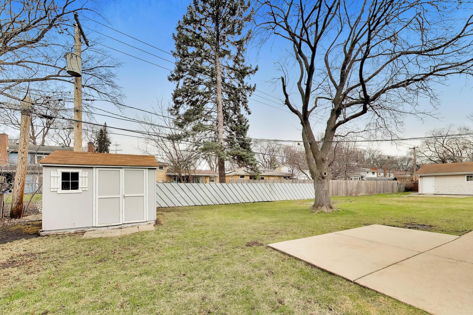 108 West Sunset Road Mount Prospect, IL 60056 - Photo 35 of 40 a view of a house with a yard