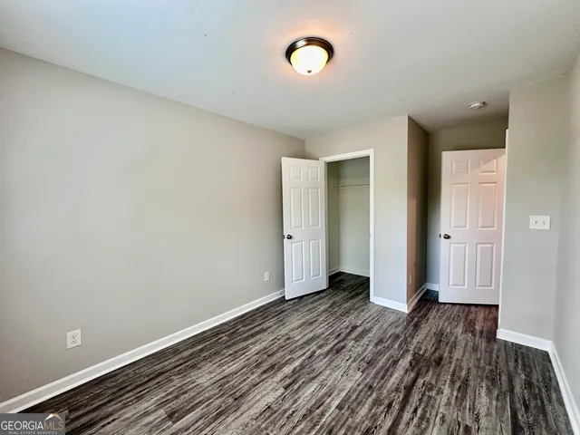 a view of a room with wooden floor