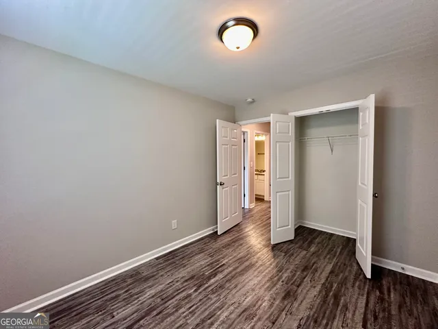 a view of an empty room and wooden floor