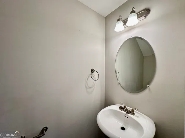 a bathroom with a sink and mirror