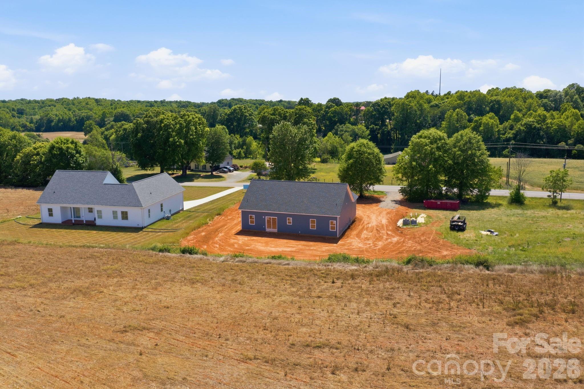 1720 Jennings Road Olin, NC 28660 - Photo 14 of 15 a view of house with yard and trees in the background