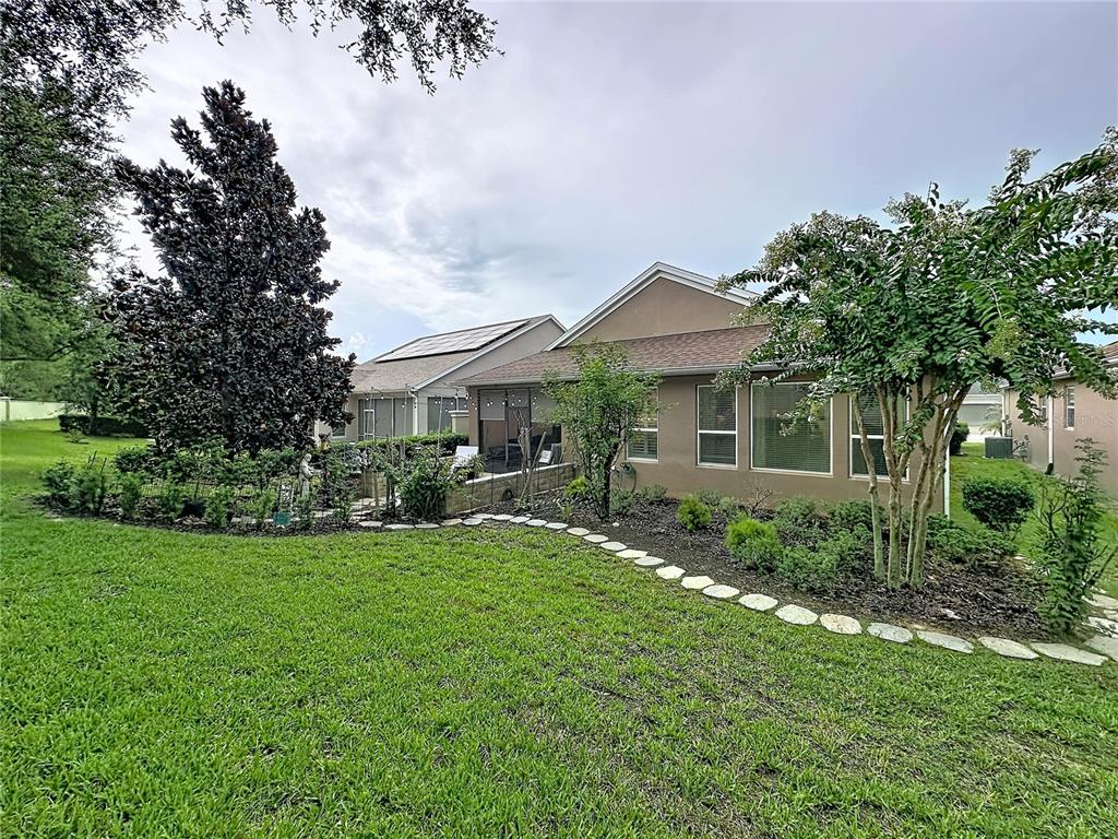 255 Silver Maple Road Groveland, FL 34736 - Photo 47 of 68 a view of a house with a big yard plants and large trees