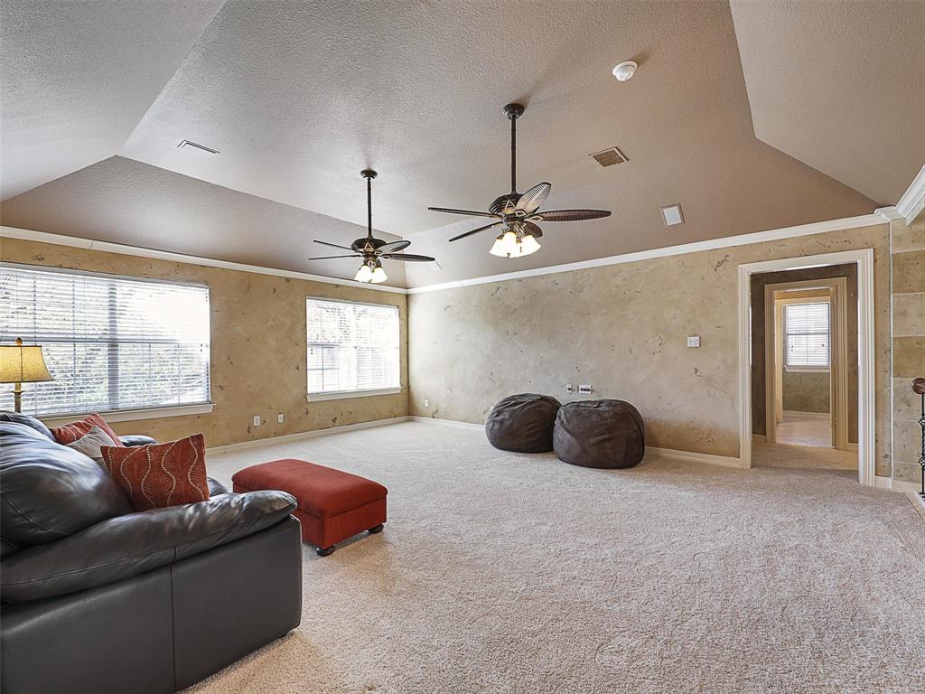 723 Bent Tree Court Coppell, TX 75019 - Photo 24 of 39 a living room with furniture and a chandelier