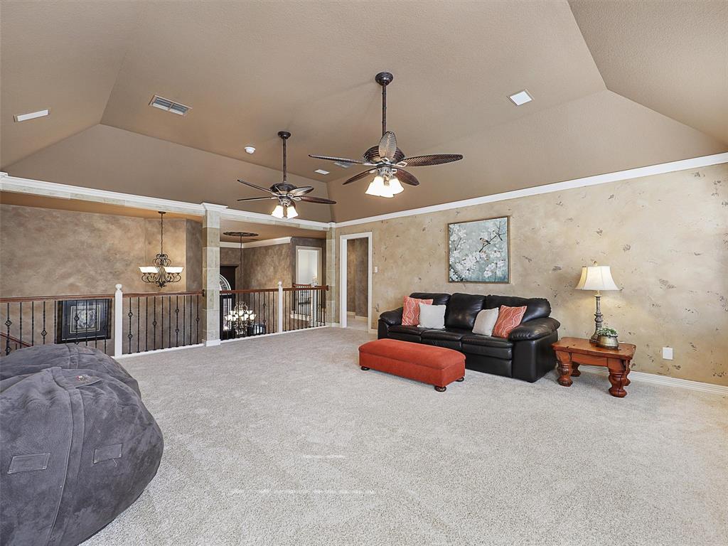 723 Bent Tree Court Coppell, TX 75019 - Photo 26 of 39 a spacious bedroom with furniture and a chandelier