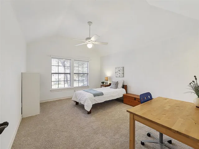 a bed room with a bed and a chandelier