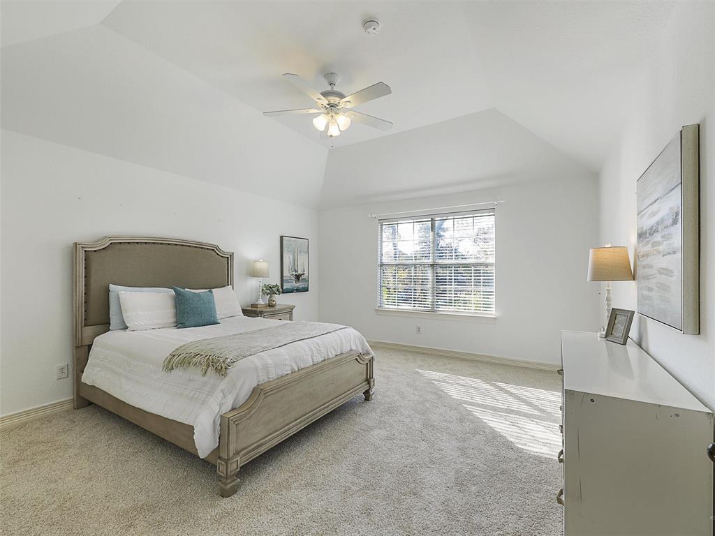 723 Bent Tree Court Coppell, TX 75019 - Photo 31 of 39 a bedroom with a bed and a chandelier