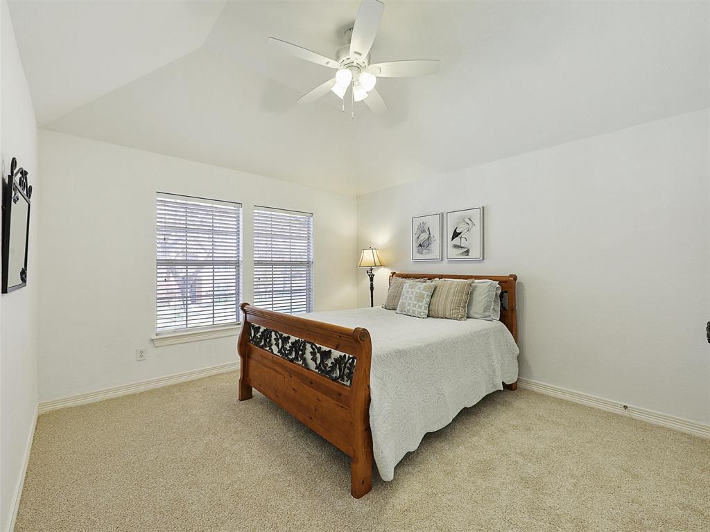 723 Bent Tree Court Coppell, TX 75019 - Photo 32 of 39 a spacious bedroom with a bed and a large window