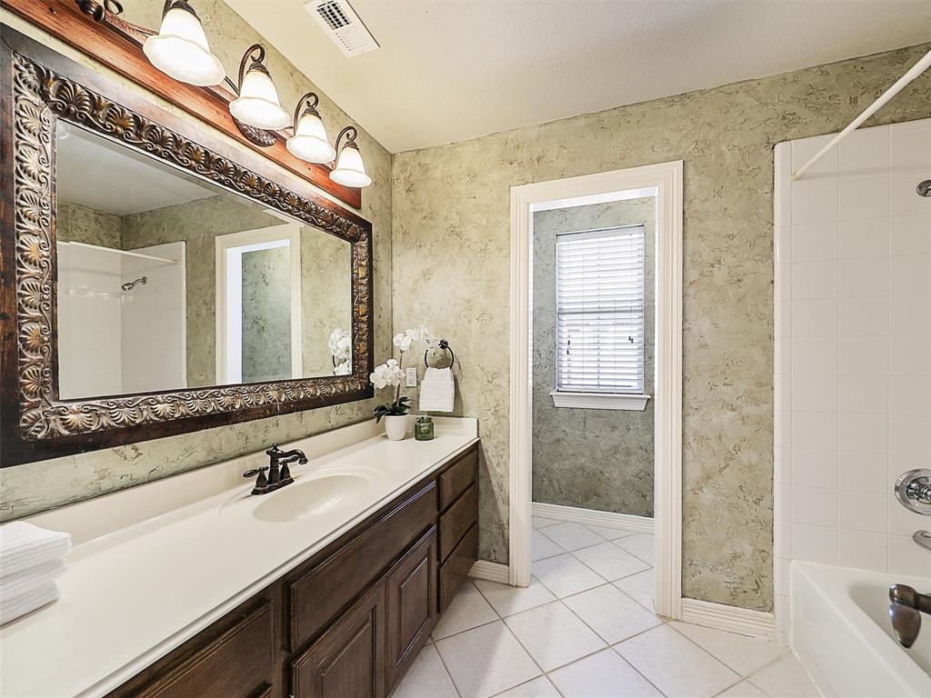 723 Bent Tree Court Coppell, TX 75019 - Photo 33 of 39 a bathroom with a sink a mirror and a shower