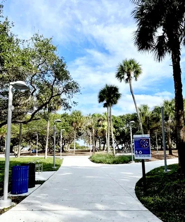 a sign board with buildings in the background