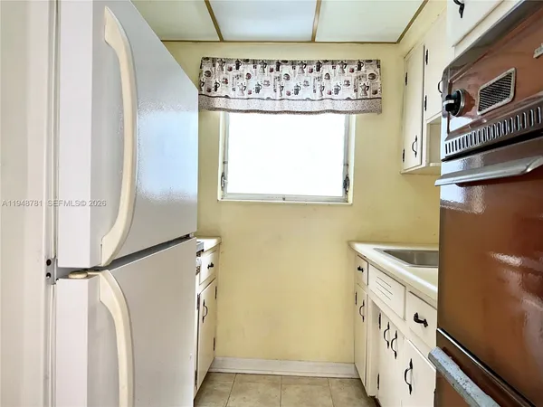a kitchen with a refrigerator a washer and dryer