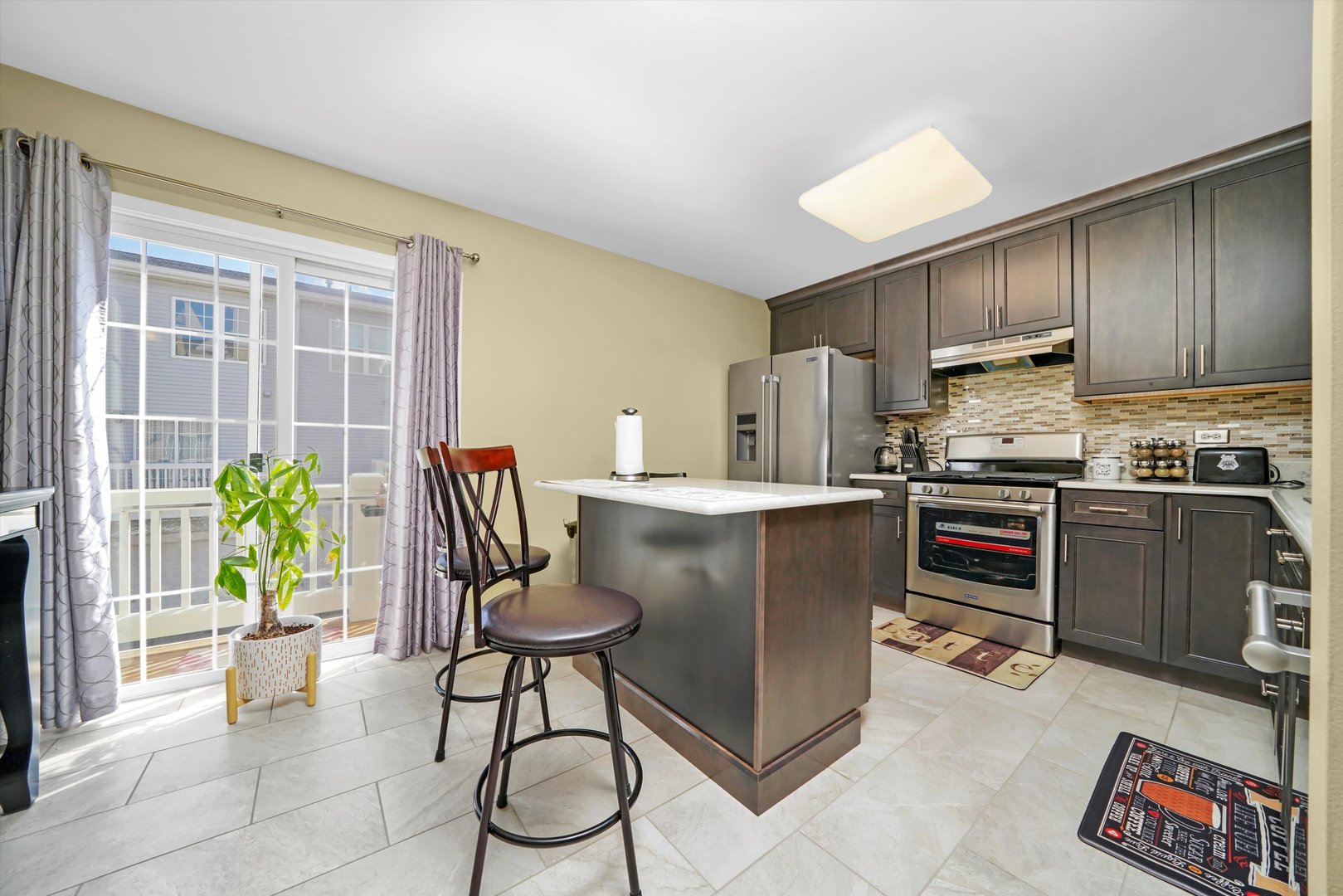 284 Holiday Lane Hainesville, IL 60073 - Photo 12 of 34 a kitchen with kitchen island a counter top space a sink stainless steel appliances and cabinets