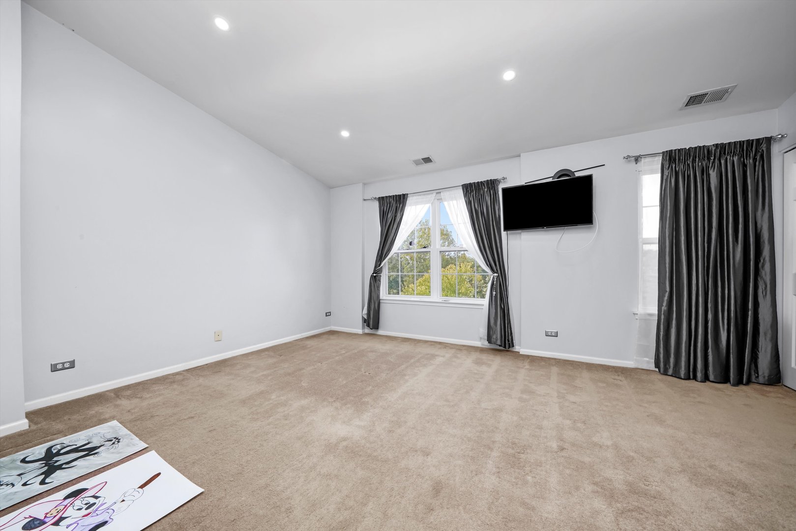 284 Holiday Lane Hainesville, IL 60073 - Photo 19 of 34 an empty room with windows and a flat screen tv