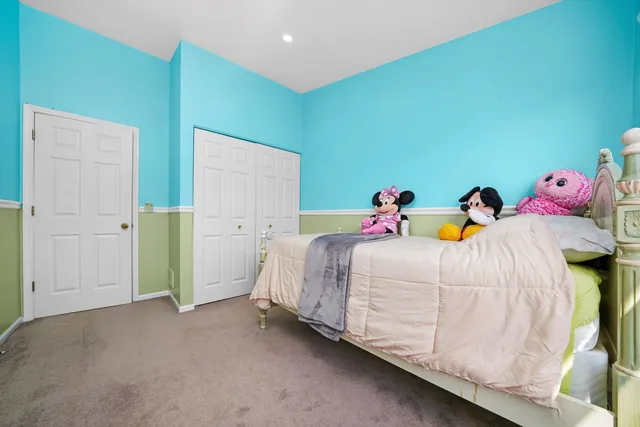 a bedroom with two beds and painted walls