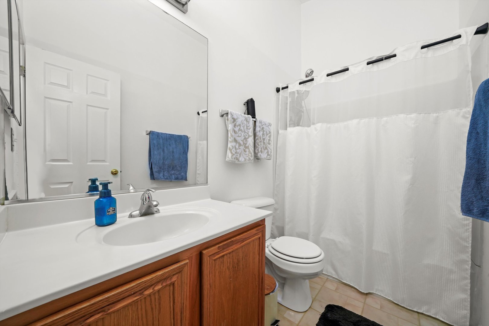 284 Holiday Lane Hainesville, IL 60073 - Photo 24 of 34 a bathroom with a sink a toilet and shower curtain