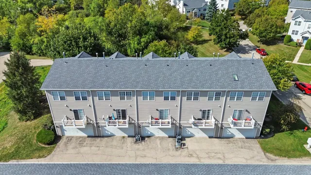 an aerial view of a house with basket ball court and outdoor seating