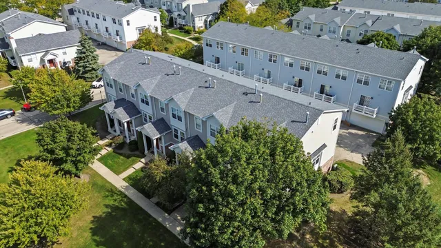 an aerial view of residential houses with outdoor space and street view
