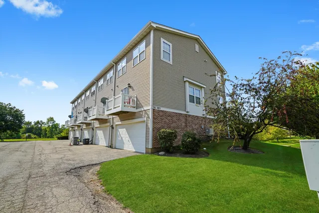 a view of house with yard and green space