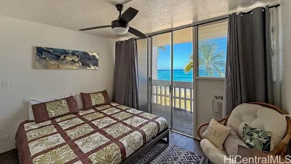 a bedroom with a bed and a painting on the wall