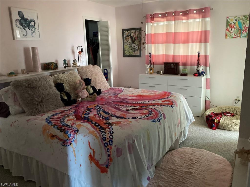 4590 28th Avenue Southwest Naples, FL 34116 - Photo 11 of 37 a bedroom with a bed and window