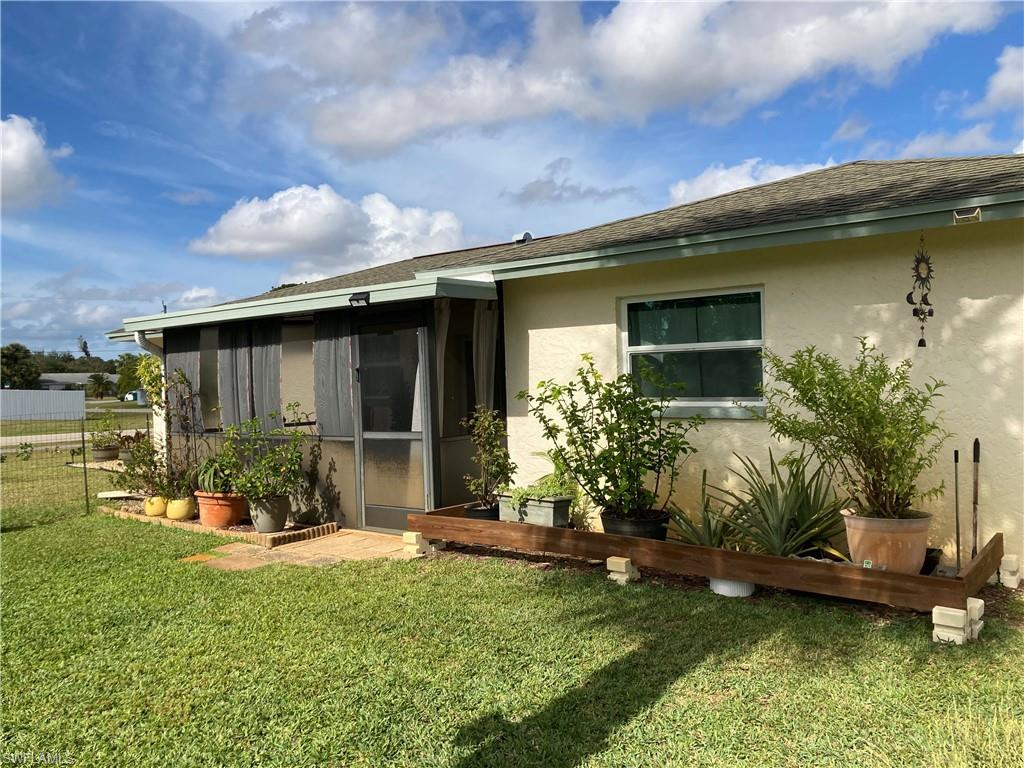 4590 28th Avenue Southwest Naples, FL 34116 - Photo 14 of 37 a view of a house with backyard sitting area and garden