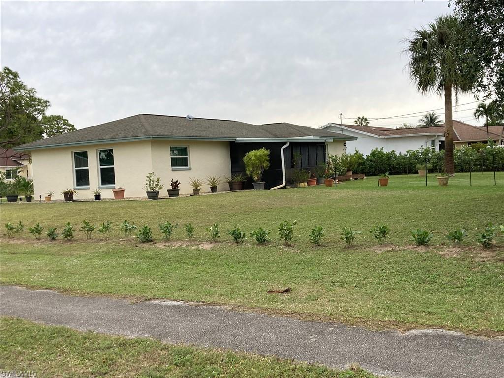 4590 28th Avenue Southwest Naples, FL 34116 - Photo 15 of 37 a front view of a house with a yard