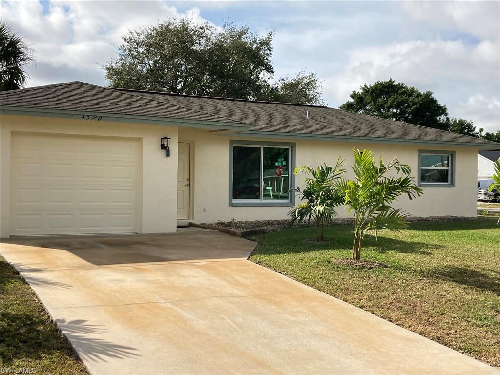 4590 28th Avenue Southwest Naples, FL 34116 - Photo 18 of 37 a front view of a house with garden