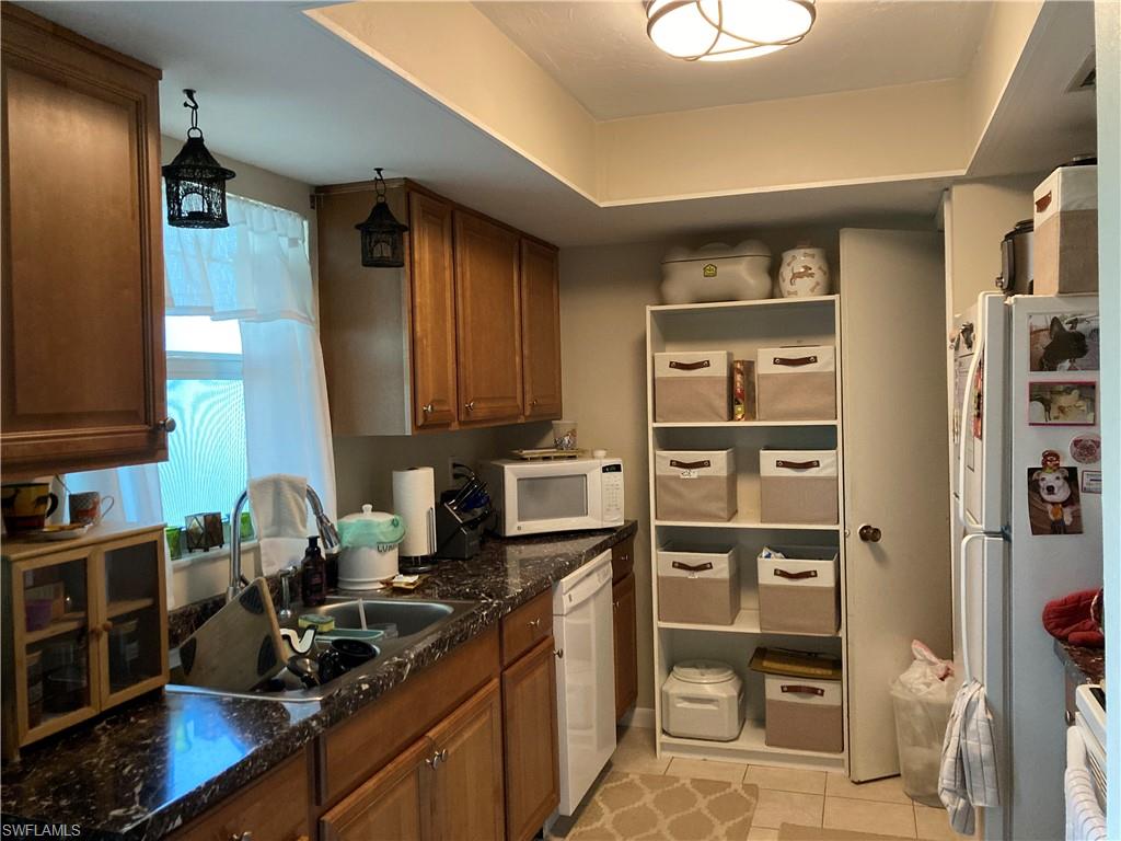 4590 28th Avenue Southwest Naples, FL 34116 - Photo 21 of 37 a kitchen with a sink cabinets and appliances