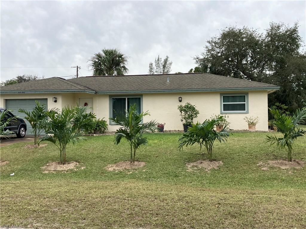 4590 28th Avenue Southwest Naples, FL 34116 - Photo 22 of 37 a front view of a house with a yard