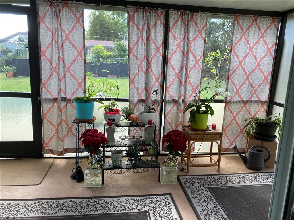 4590 28th Avenue Southwest Naples, FL 34116 - Photo 24 of 37 a living room with furniture and a floor to ceiling window