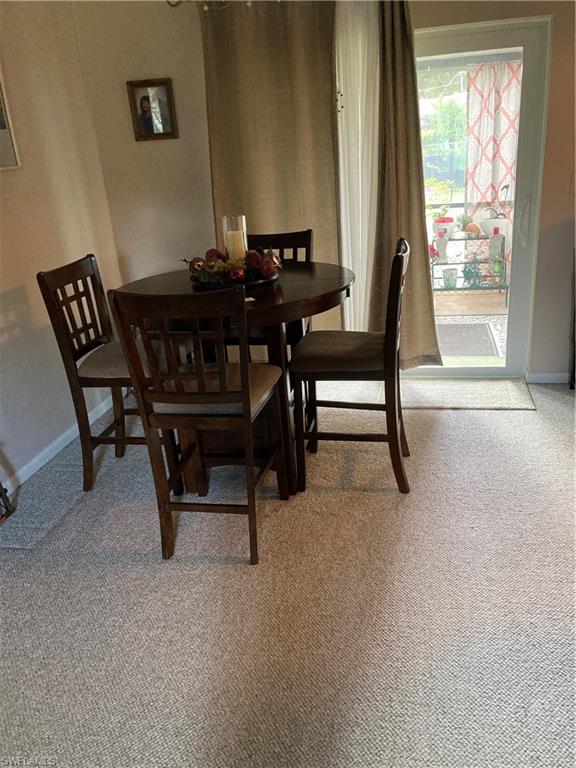 4590 28th Avenue Southwest Naples, FL 34116 - Photo 26 of 37 a view of a dining room with furniture and a window