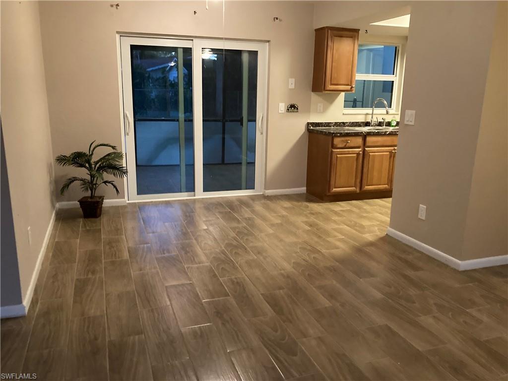 4590 28th Avenue Southwest Naples, FL 34116 - Photo 27 of 37 a view of a kitchen with a sink and a stove