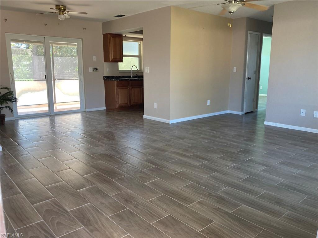 4590 28th Avenue Southwest Naples, FL 34116 - Photo 32 of 37 an empty room with wooden floor and windows