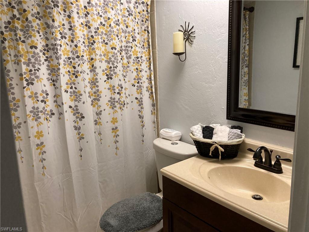 4590 28th Avenue Southwest Naples, FL 34116 - Photo 6 of 37 a bathroom with a sink toilet and shower